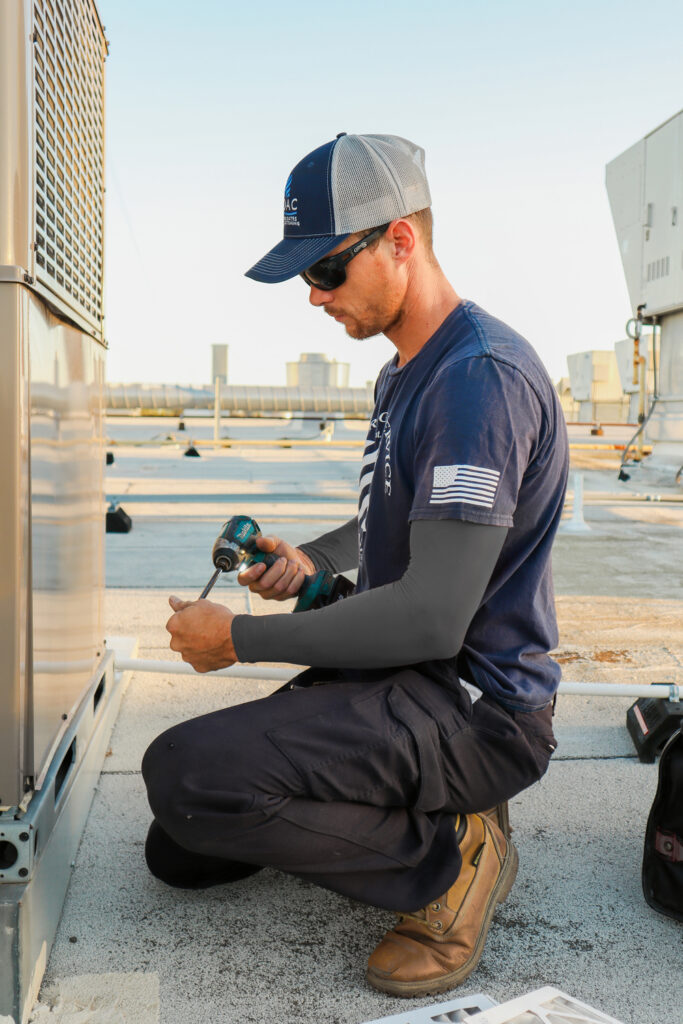 Technician with screw opening HVAC unit