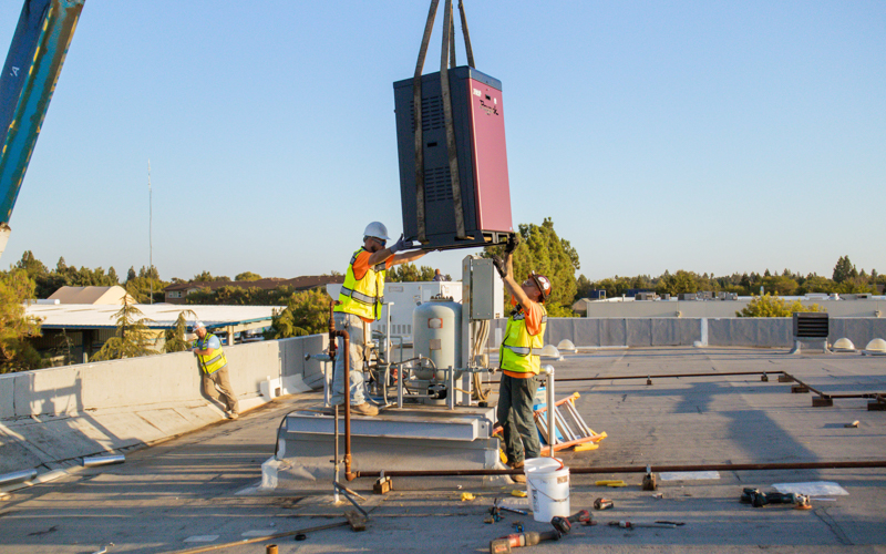 Installing a new boiler on the roof in Davis, CA