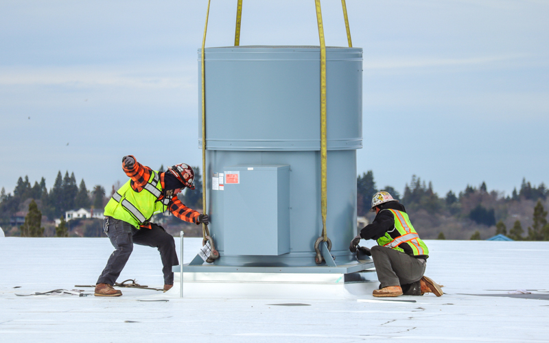 Exhaust fans being installed on roof