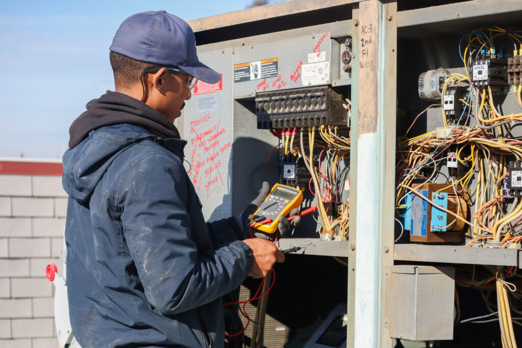 HVAC tech working on unit